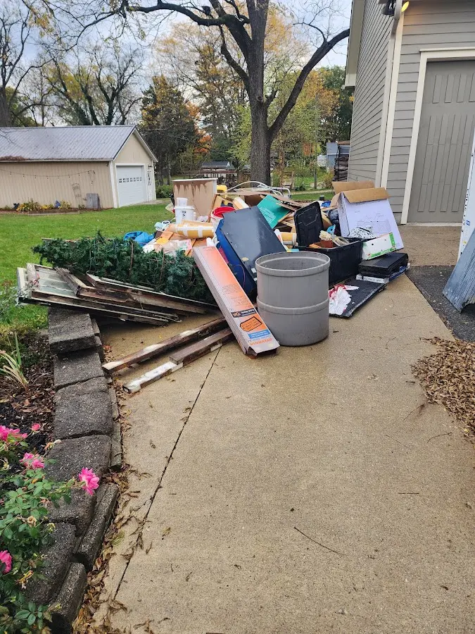 Dumpster being loaded with debris for Roofing Dumpster Rental in North Brookfield